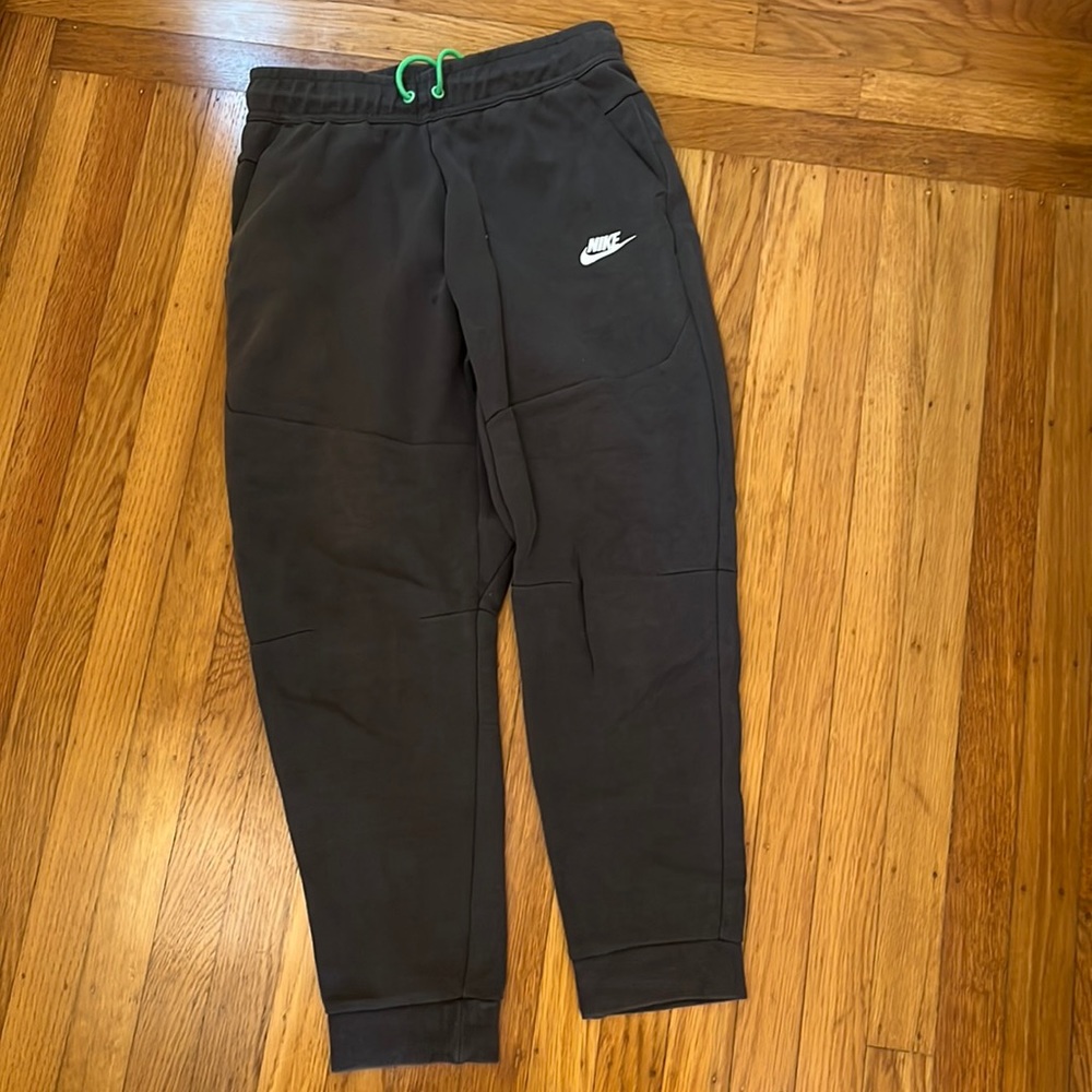 Boys Nike Tech Fleece pants. Dark gray with green drawstrings. Size youth XL.